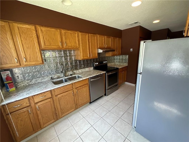 511 Child St Unit 101, Warren, RI 02885 - kitchen featuring stainless steel appliances, under cabinet range hood, tasteful backsplash, brown cabinets, and light tile patterned floors