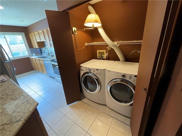 511 Child St Unit 101, Warren, RI 02885 - laundry area featuring separate washer and dryer, light tile patterned flooring, and a textured ceiling