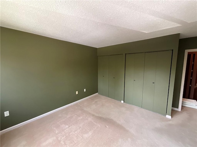 511 Child St Unit 101, Warren, RI 02885 - unfurnished bedroom with carpet, a textured ceiling, and multiple closets