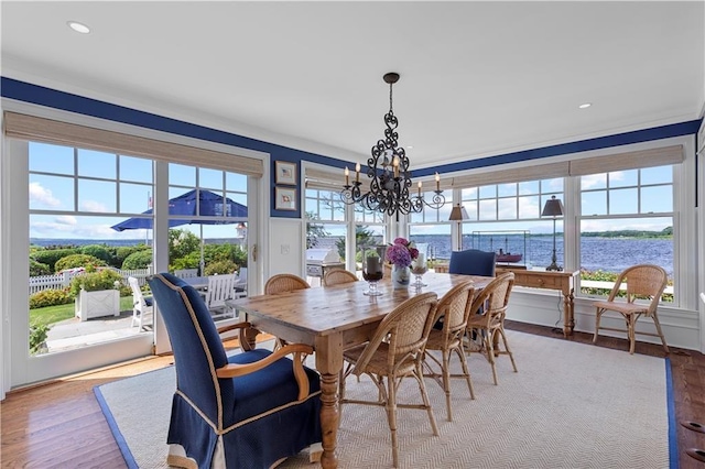 9 Arraquat Rd, Westerly, RI 02891 - dining space featuring wood finished floors, a chandelier, a water view, and recessed lighting