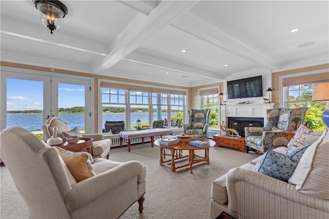 9 Arraquat Rd, Westerly, RI 02891 - living area featuring beam ceiling, light carpet, healthy amount of natural light, a fireplace, and a water view