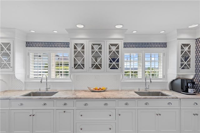 9 Arraquat Rd, Westerly, RI 02891 - kitchen featuring white cabinetry, glass insert cabinets, ornamental molding, light stone counters, and recessed lighting