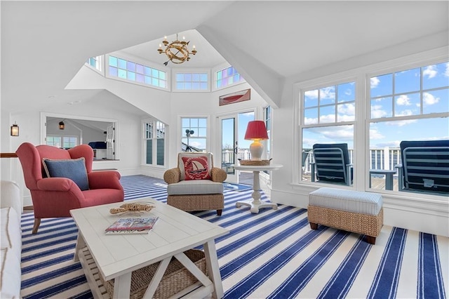 9 Arraquat Rd, Westerly, RI 02891 - living area with carpet, high vaulted ceiling, and a chandelier
