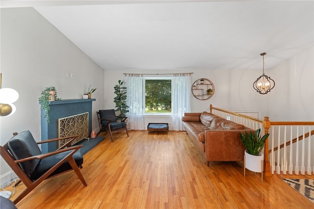 11 Burr Ave, Barrington, RI 02806 - living room with light wood finished floors, a fireplace with raised hearth, and a chandelier