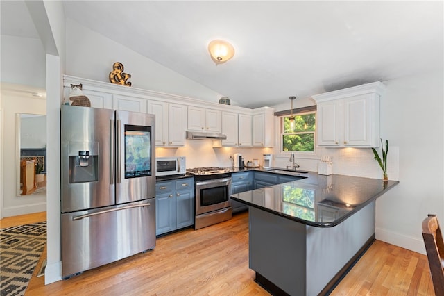 11 Burr Ave, Barrington, RI 02806 - kitchen featuring stainless steel appliances, under cabinet range hood, a peninsula, dark countertops, and white cabinetry