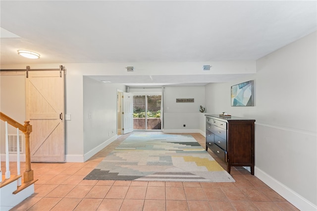 11 Burr Ave, Barrington, RI 02806 - corridor with light tile patterned floors, a barn door, and stairs