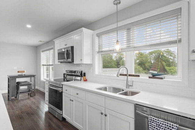 15 Spadina Ave, Warwick, RI 02889 - kitchen with stainless steel appliances, plenty of natural light, backsplash, dark wood-type flooring, and recessed lighting