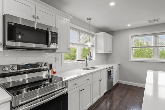 15 Spadina Ave, Warwick, RI 02889 - kitchen featuring stainless steel appliances, light countertops, dark wood finished floors, tasteful backsplash, and recessed lighting