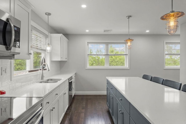 15 Spadina Ave, Warwick, RI 02889 - kitchen with stainless steel appliances, plenty of natural light, light countertops, white cabinetry, and recessed lighting
