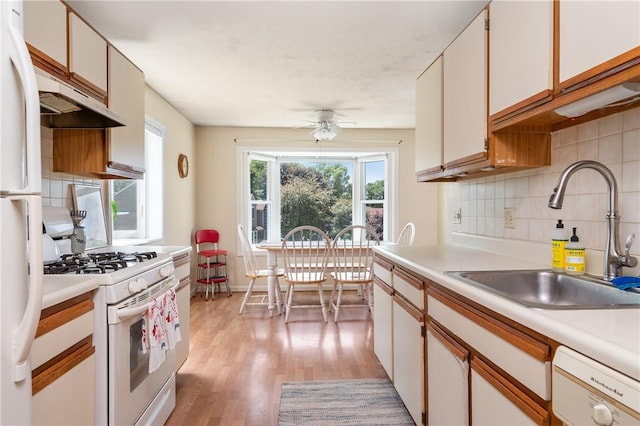 200 Heroux Blvd Unit 908, Cumberland, RI 02864 - kitchen with white appliances, light countertops, decorative backsplash, under cabinet range hood, and light wood finished floors