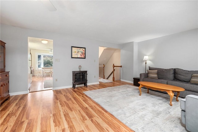 200 Heroux Blvd Unit 908, Cumberland, RI 02864 - living room with a wood stove and light wood finished floors