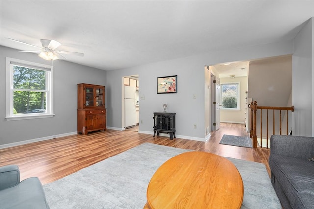 200 Heroux Blvd Unit 908, Cumberland, RI 02864 - living room with a wood stove, light wood finished floors, and a ceiling fan