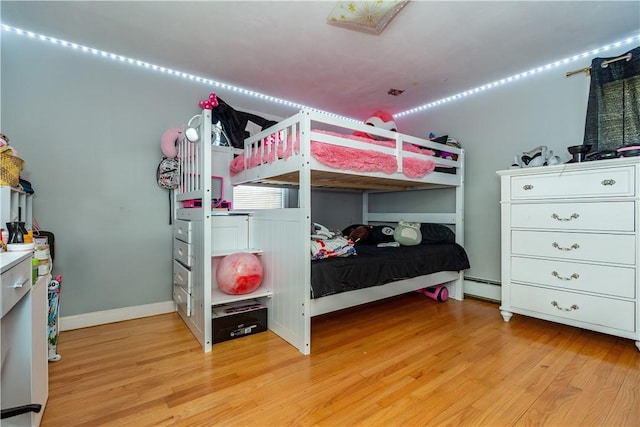 111 Belgium St, Cranston, RI 02920 - bedroom with light wood-style floors and a baseboard heating unit