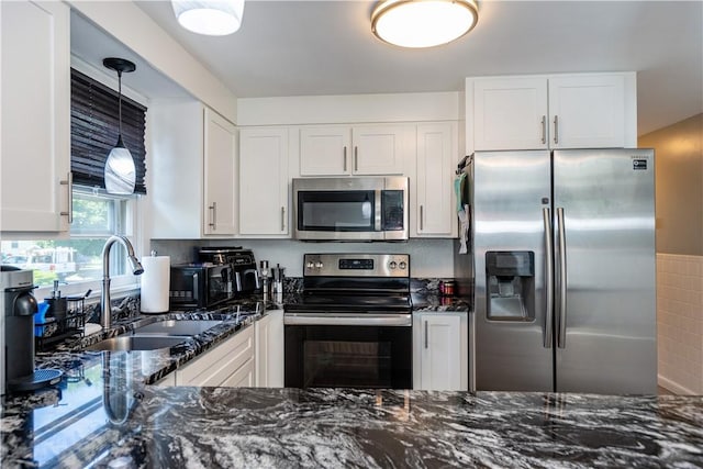111 Belgium St, Cranston, RI 02920 - kitchen featuring stainless steel appliances, dark stone counters, and white cabinetry