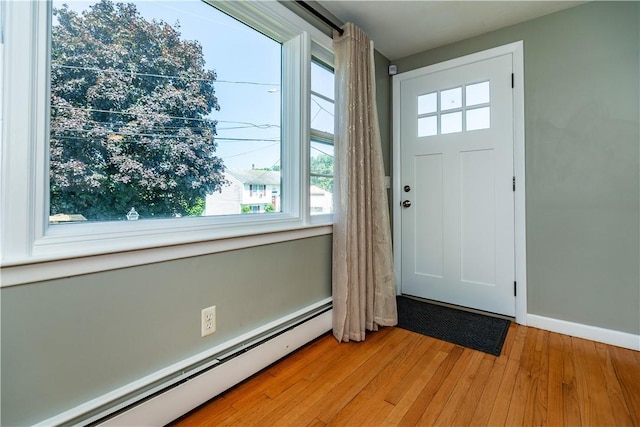 111 Belgium St, Cranston, RI 02920 - foyer entrance featuring a baseboard heating unit, plenty of natural light, and light wood-style floors