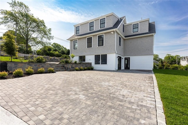 35 Coggeshall Ave, Newport, RI 02840 - view of front facade with a front lawn and decorative driveway
