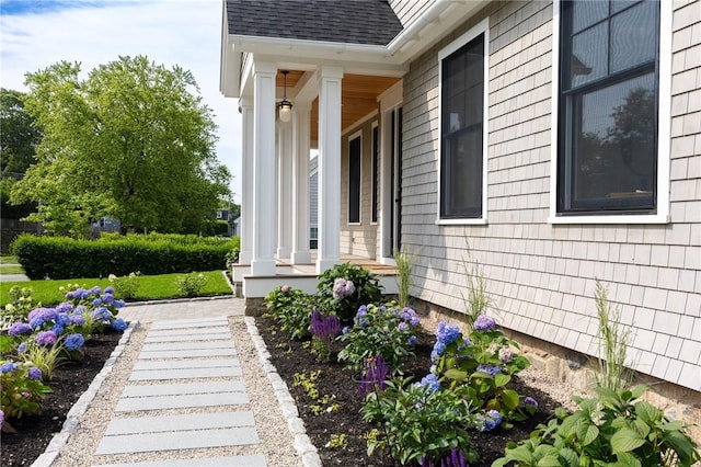 35 Coggeshall Ave, Newport, RI 02840 - view of side of property with a shingled roof and covered porch