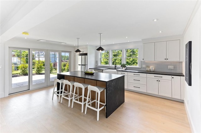 35 Coggeshall Ave, Newport, RI 02840 - kitchen featuring dark countertops, freestanding refrigerator, backsplash, light wood-style floors, and recessed lighting
