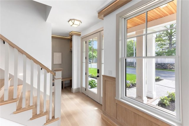 35 Coggeshall Ave, Newport, RI 02840 - foyer featuring plenty of natural light, stairs, light wood-style flooring, and wainscoting
