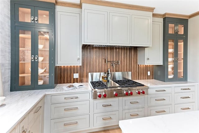 35 Coggeshall Ave, Newport, RI 02840 - kitchen featuring decorative backsplash, stainless steel gas stovetop, glass insert cabinets, and light stone countertops