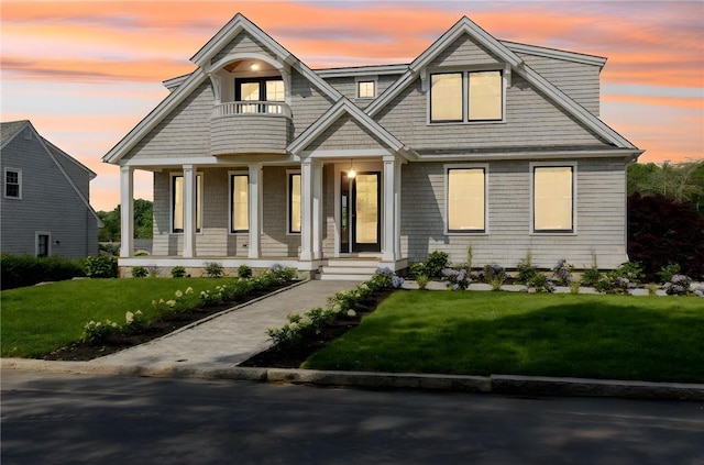 35 Coggeshall Ave, Newport, RI 02840 - view of front of house featuring a balcony, covered porch, and a front lawn