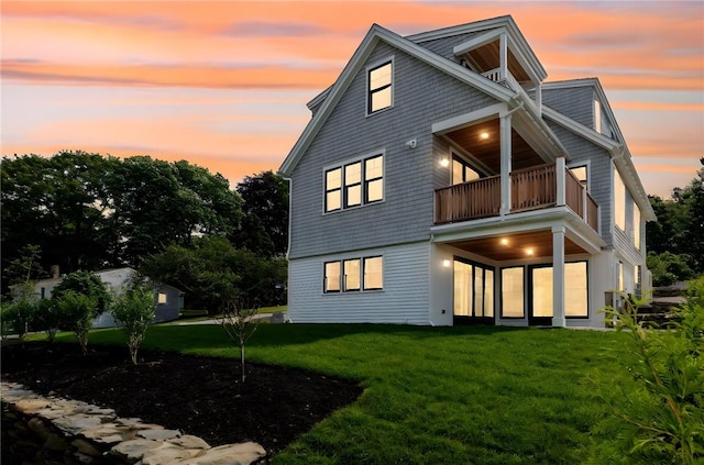 35 Coggeshall Ave, Newport, RI 02840 - back of property at dusk featuring a balcony and a yard