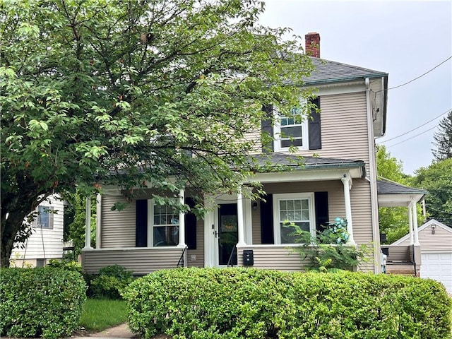 11 Potter Ave, West Warwick, RI 02893 - view of front facade featuring a chimney, a garage, a porch, an outbuilding, and a shingled roof