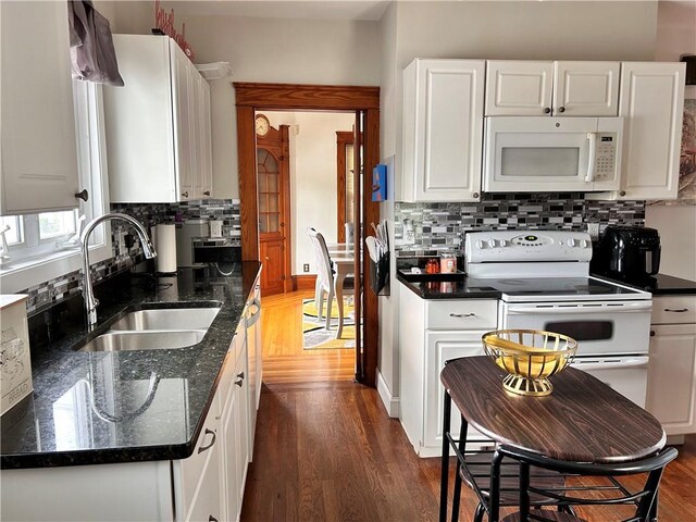 11 Potter Ave, West Warwick, RI 02893 - kitchen featuring white appliances, wood finished floors, and decorative backsplash