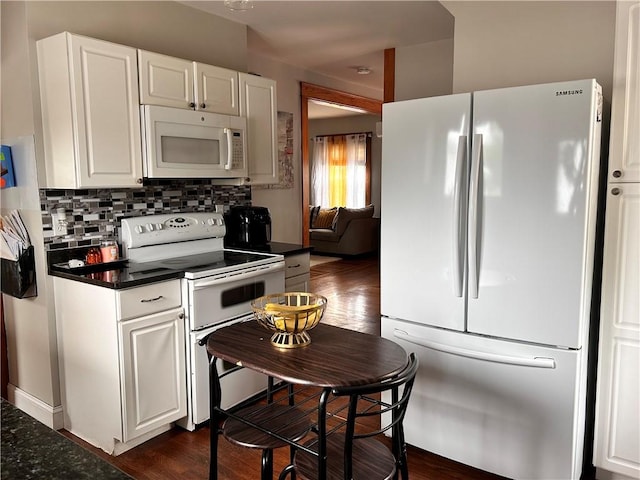 11 Potter Ave, West Warwick, RI 02893 - kitchen featuring white appliances, dark countertops, tasteful backsplash, white cabinetry, and dark wood finished floors