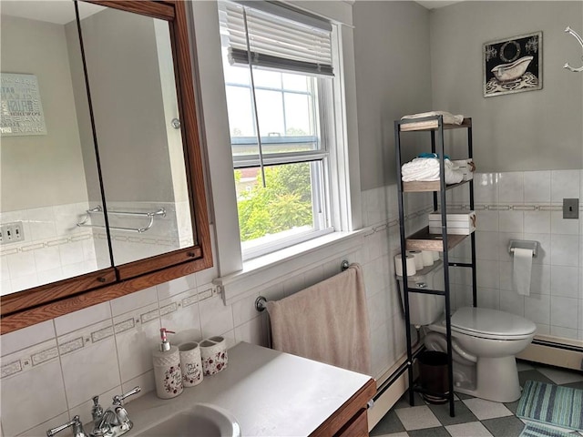 11 Potter Ave, West Warwick, RI 02893 - bathroom featuring tile walls, a baseboard radiator, tile patterned floors, wainscoting, and vanity