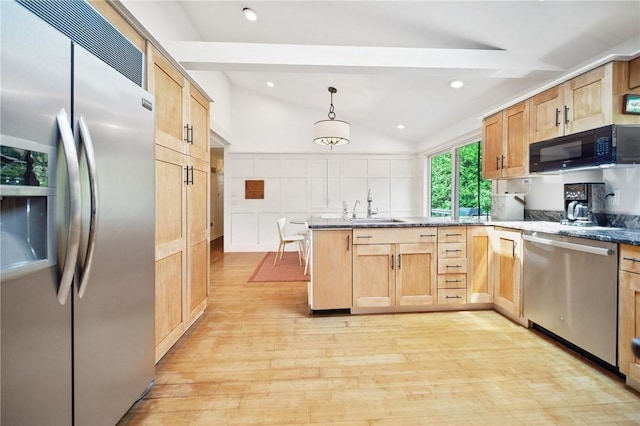 20 Wagner Rd, Westerly, RI 02891 - kitchen featuring stainless steel appliances, light wood finished floors, a peninsula, a decorative wall, and light brown cabinetry
