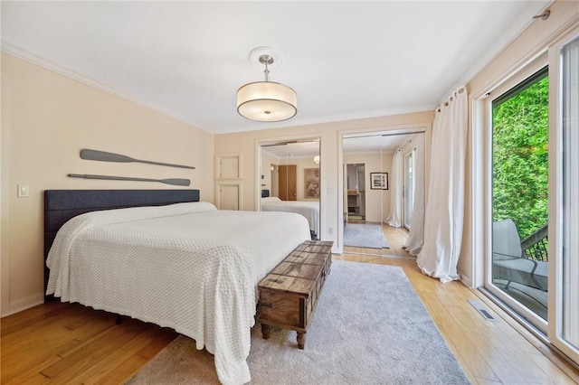 20 Wagner Rd, Westerly, RI 02891 - bedroom featuring access to outside, light wood-style flooring, two closets, and ornamental molding