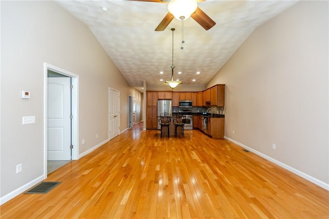 1285 Hartford Ave Unit 25, Johnston, RI 02919 - living room with light wood finished floors, vaulted ceiling, and a ceiling fan