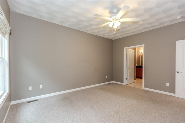 1285 Hartford Ave Unit 25, Johnston, RI 02919 - unfurnished bedroom featuring light carpet, ensuite bathroom, and ceiling fan
