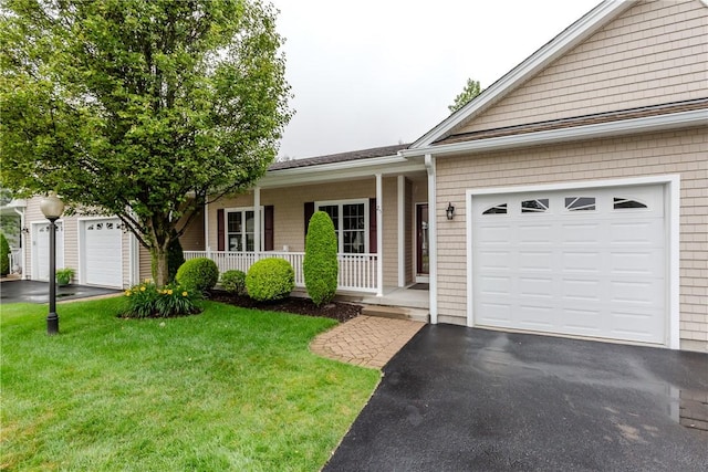 1285 Hartford Ave Unit 25, Johnston, RI 02919 - ranch-style home featuring covered porch, a front yard, an attached garage, and driveway