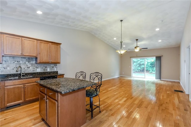 1285 Hartford Ave Unit 25, Johnston, RI 02919 - kitchen with a kitchen breakfast bar, ceiling fan, a center island, decorative backsplash, and open floor plan