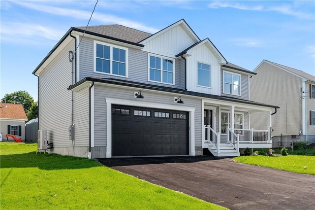 52 Governor St, Cumberland, RI 02864 - view of front of home featuring a garage, covered porch, a front yard, driveway, and board and batten siding