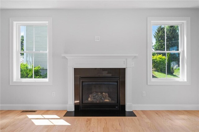 52 Governor St, Cumberland, RI 02864 - detailed view of wood finished floors and a fireplace with flush hearth