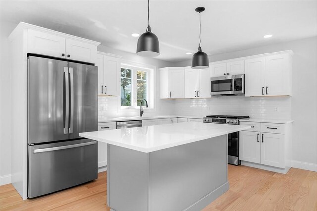 52 Governor St, Cumberland, RI 02864 - kitchen with appliances with stainless steel finishes, recessed lighting, light wood finished floors, white cabinets, and light countertops