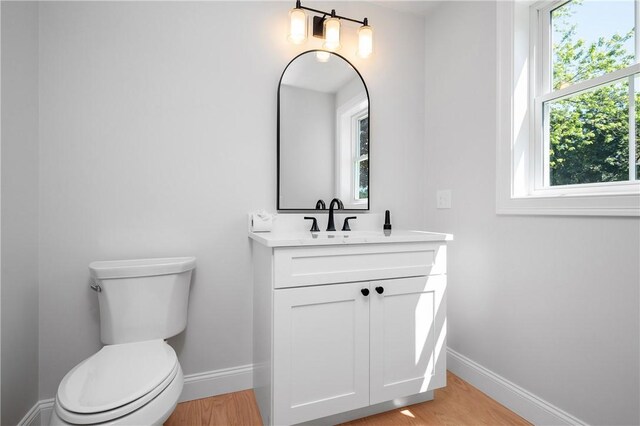 52 Governor St, Cumberland, RI 02864 - bathroom featuring vanity, healthy amount of natural light, and wood finished floors