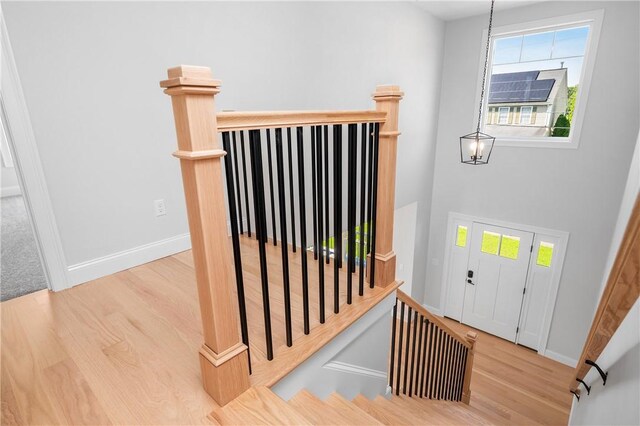 52 Governor St, Cumberland, RI 02864 - staircase featuring wood finished floors, plenty of natural light, and a chandelier