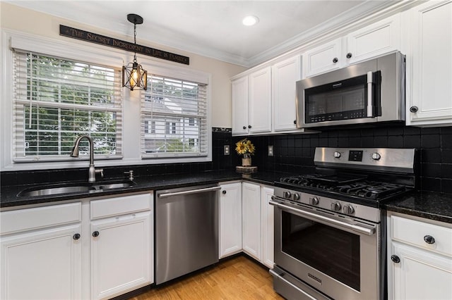 88 Red Brook Ln Unit 88, West Warwick, RI 02893 - kitchen with appliances with stainless steel finishes, crown molding, white cabinets, dark stone counters, and backsplash