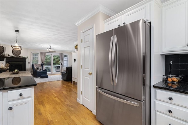 88 Red Brook Ln Unit 88, West Warwick, RI 02893 - kitchen featuring freestanding refrigerator, white cabinets, light wood-type flooring, a fireplace, and open floor plan