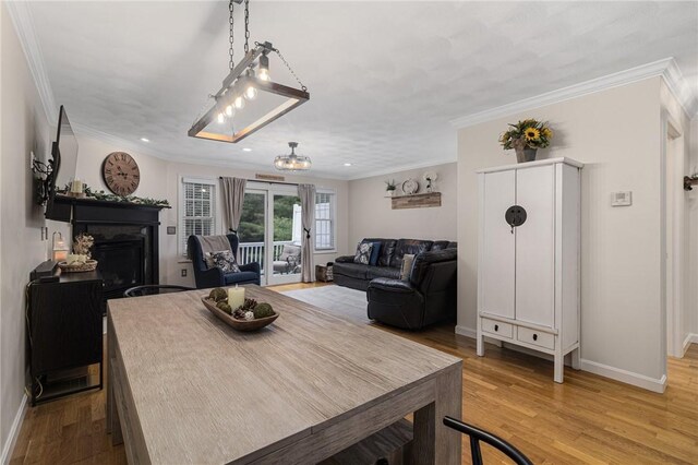 88 Red Brook Ln Unit 88, West Warwick, RI 02893 - dining space with light wood-style floors, ornamental molding, recessed lighting, and a fireplace