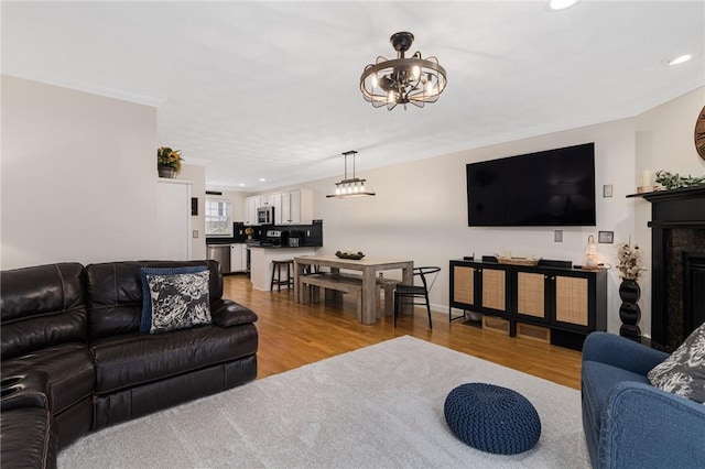 88 Red Brook Ln Unit 88, West Warwick, RI 02893 - living room with wood finished floors, recessed lighting, crown molding, a fireplace, and a chandelier