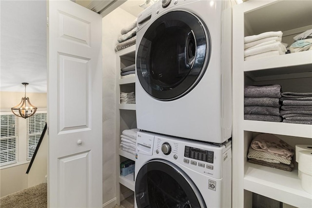 88 Red Brook Ln Unit 88, West Warwick, RI 02893 - laundry room featuring stacked washer and clothes dryer, a chandelier, and carpet flooring