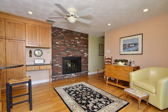 1 Butts Rock Rd, Little Compton, RI 02837 - living room with ceiling fan, light wood-style flooring, a fireplace, and recessed lighting