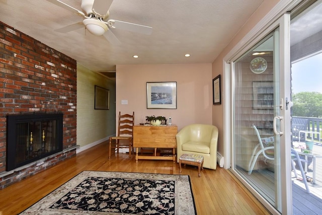1 Butts Rock Rd, Little Compton, RI 02837 - sitting room featuring hardwood / wood-style floors, ceiling fan, a brick fireplace, and recessed lighting