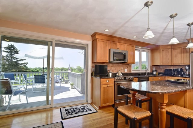 1 Butts Rock Rd, Little Compton, RI 02837 - kitchen featuring stainless steel appliances, light wood finished floors, backsplash, recessed lighting, and decorative light fixtures
