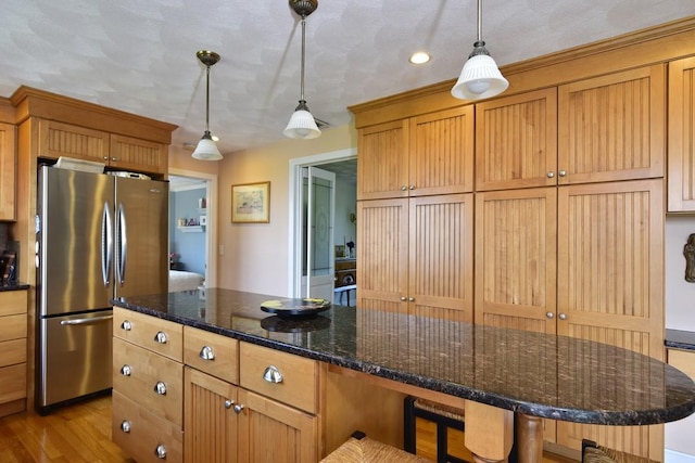 1 Butts Rock Rd, Little Compton, RI 02837 - kitchen featuring freestanding refrigerator, a breakfast bar area, pendant lighting, and light wood-type flooring